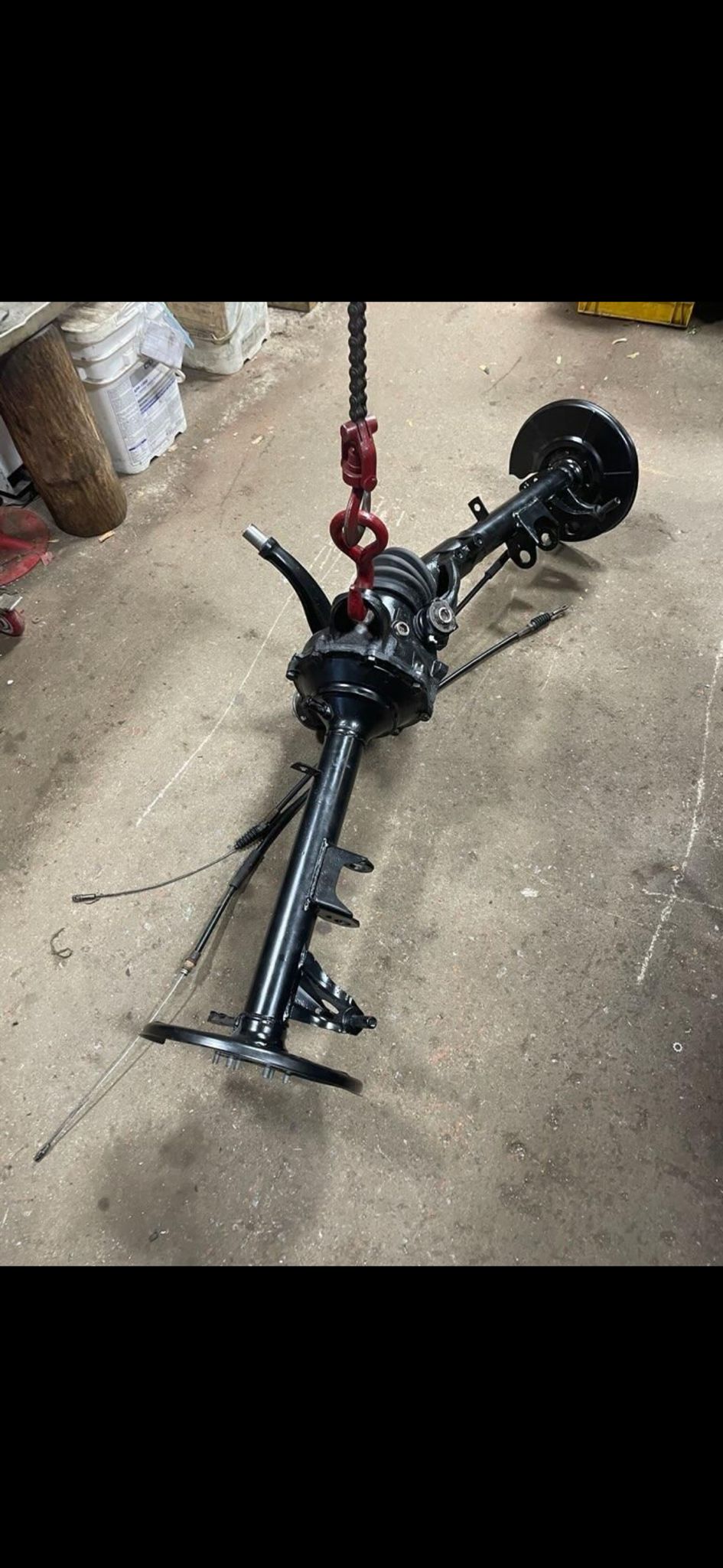 Transmission case and parts on shelves in a restoration shop